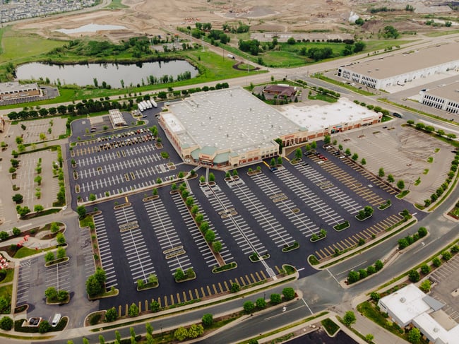 Large commercial parking lot that has been freshly paved and line striping