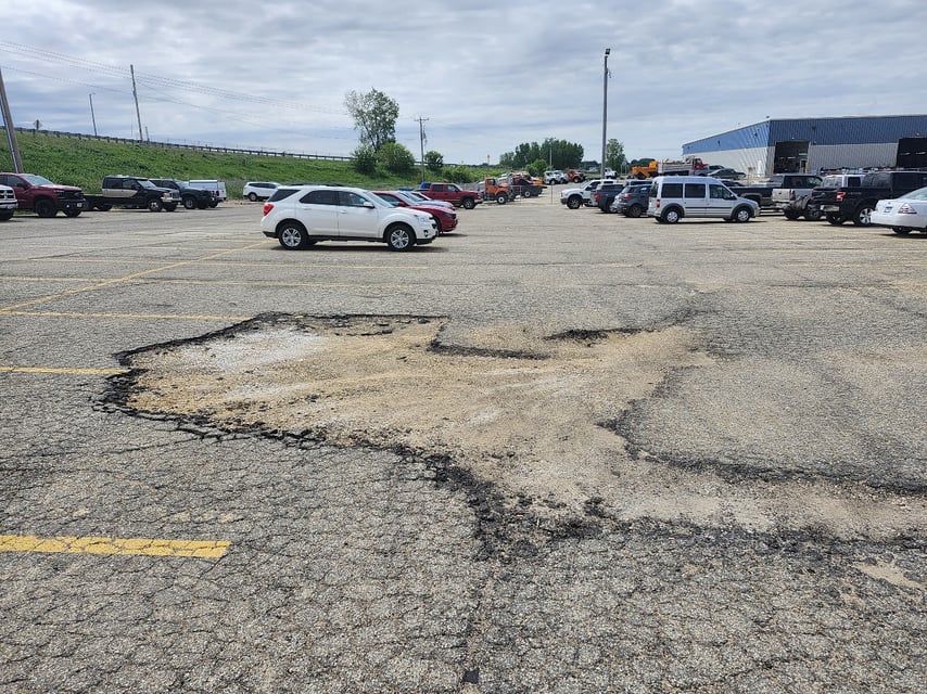 Large Parking Lot Pothole with sand
