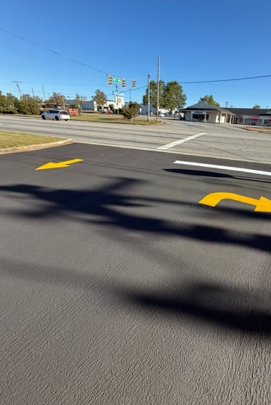 micropaved roadway with yellow directional arrows to inform traffic flow