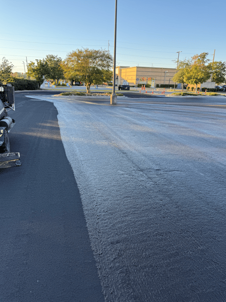 freshly applied asphalt microsurfacing on commercial parking lot and roadway