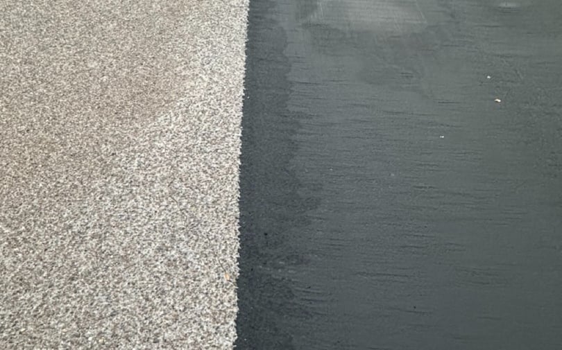 asphalt pavement before and after with worn surface on left and fresh microsurfacing on the right