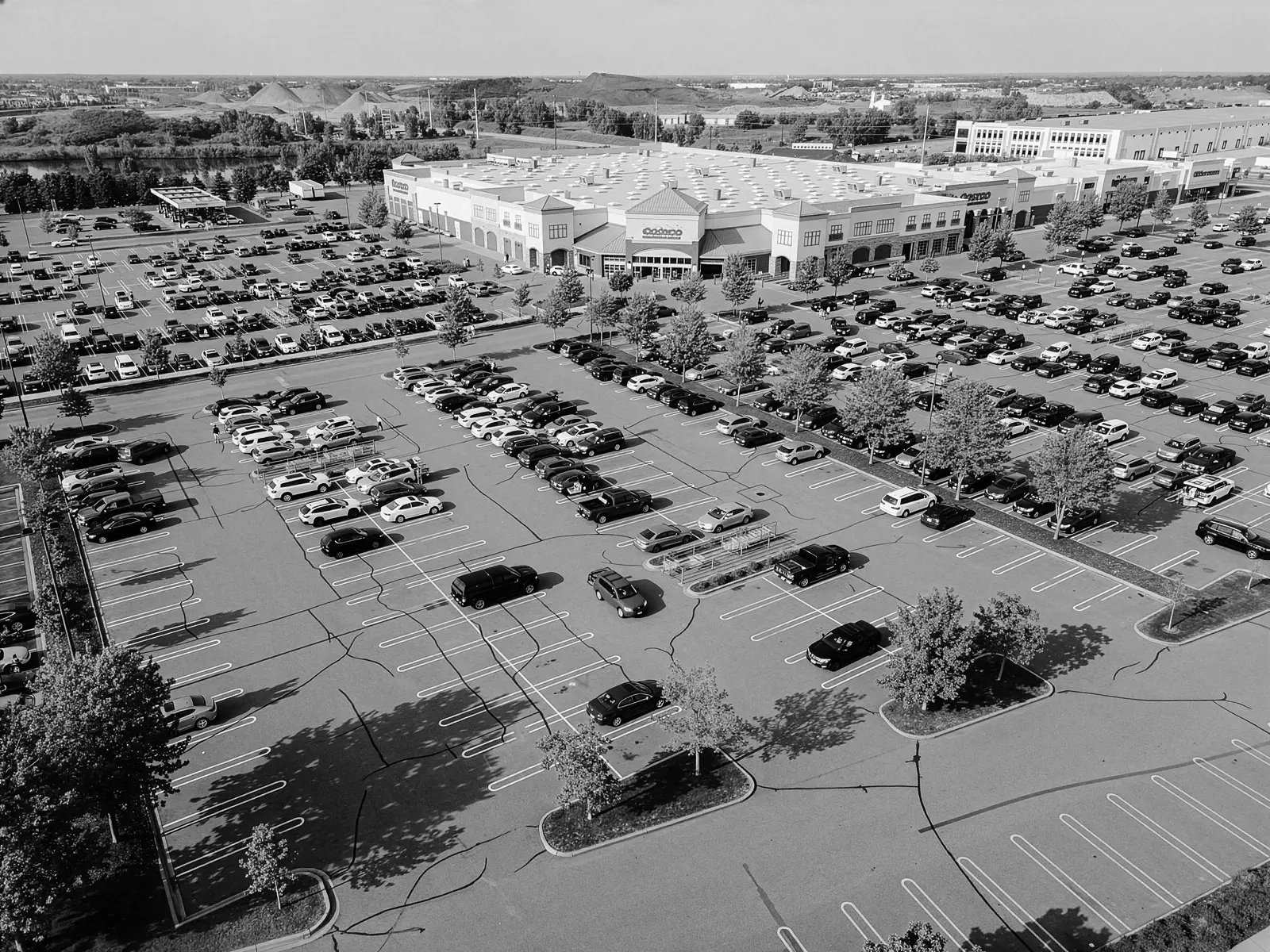 Aerial view of commercial parking lot with crack sealing repairs and fresh striping