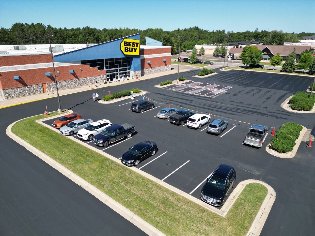 Best Buy major retailer parking lot after micropaving application with cars parked in lot